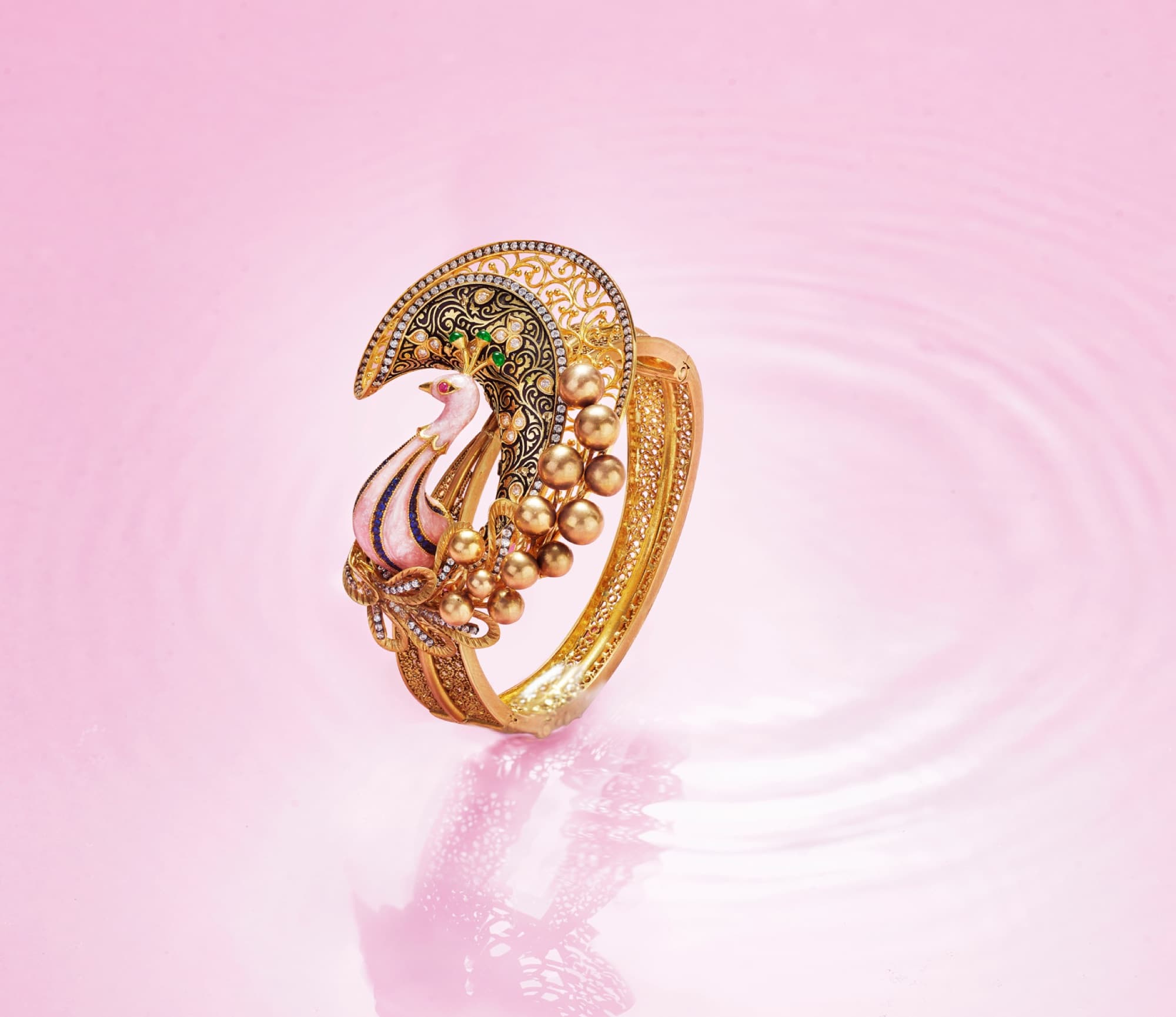 A peacock ring with intricate enamel and gold detailing
